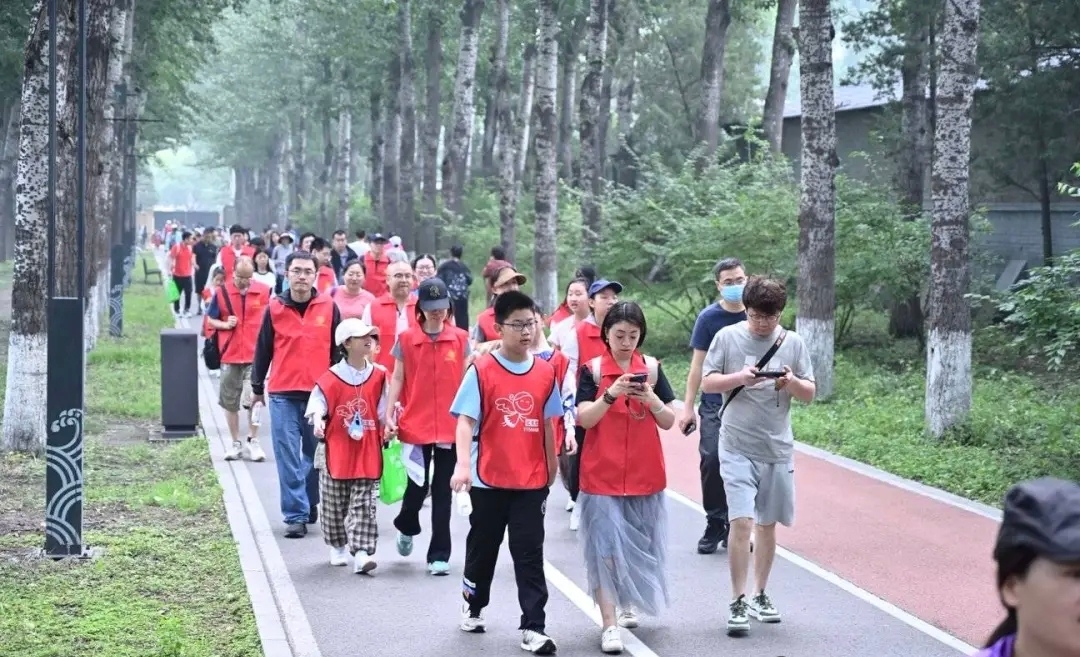Volunteers walking through a tree-lined route